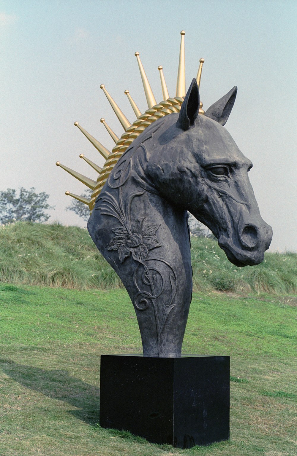 a statue of a horse with spikes on its head