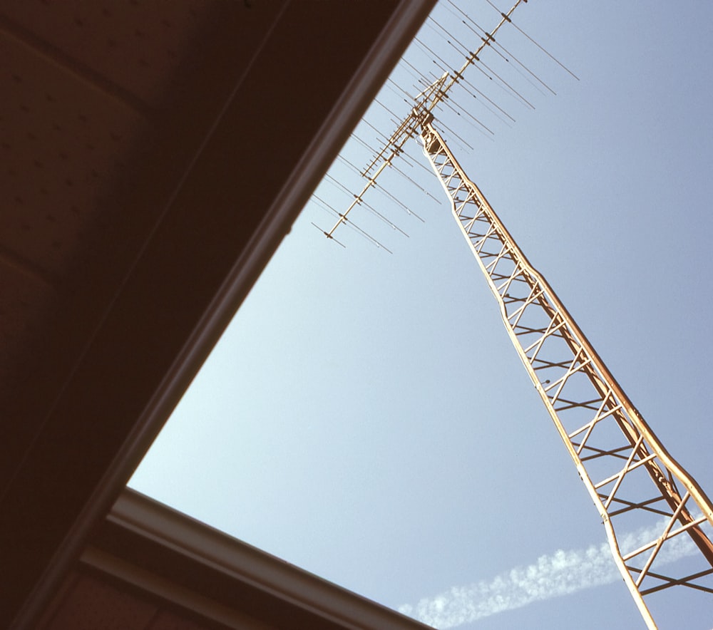 a tall antenna sitting on top of a roof