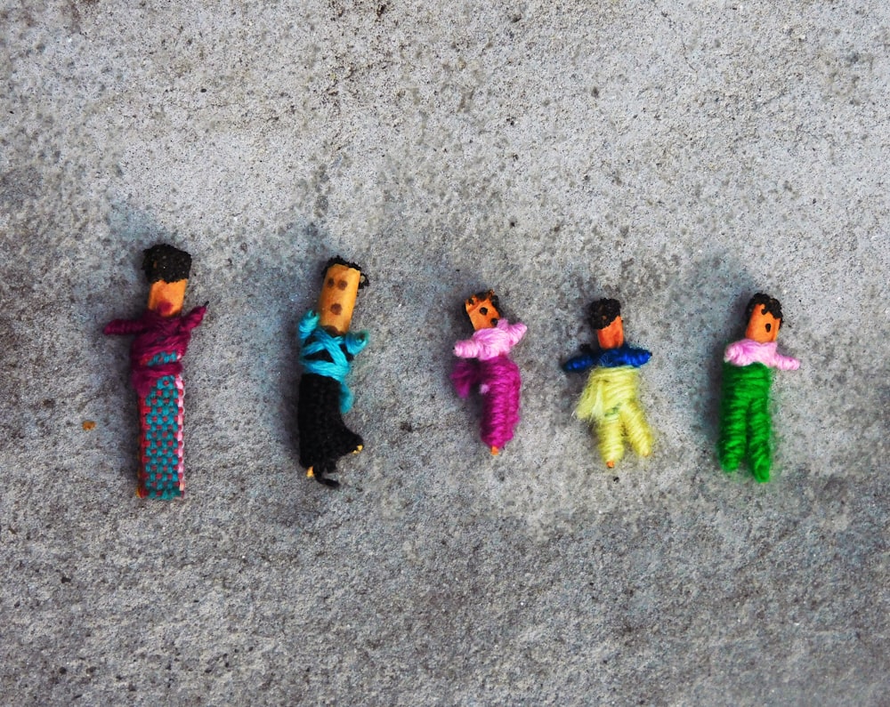 a group of toy people laying on the ground