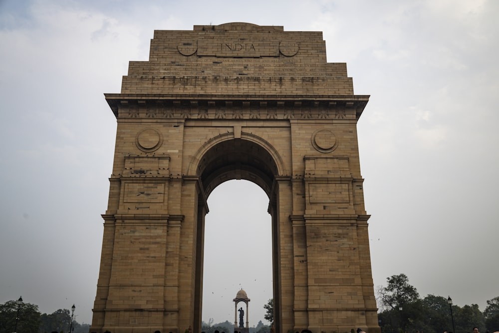 a large stone arch with a clock on it