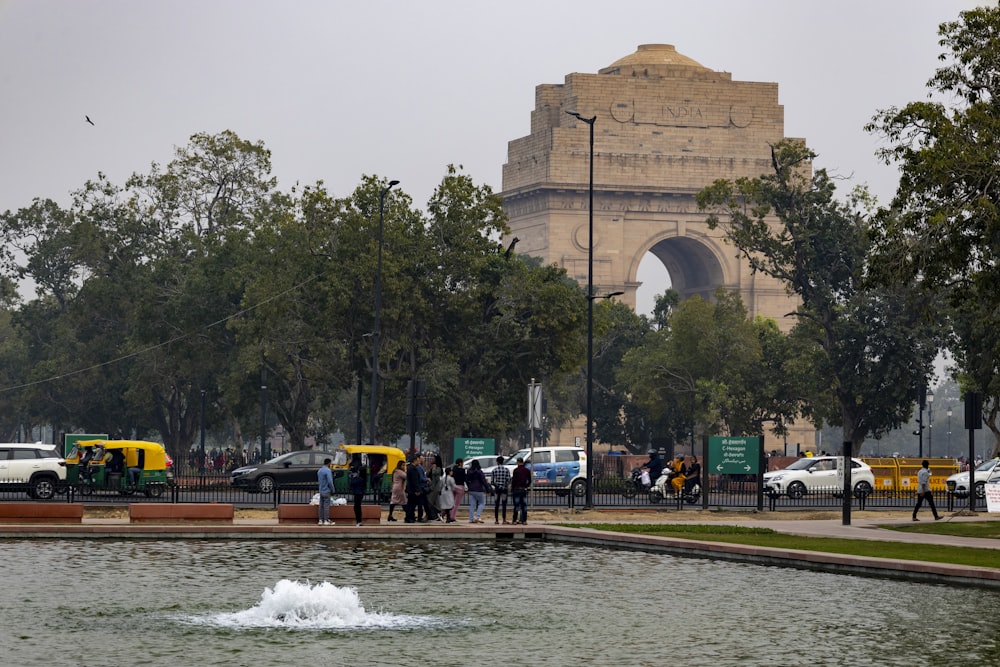 a group of people standing around a fountain