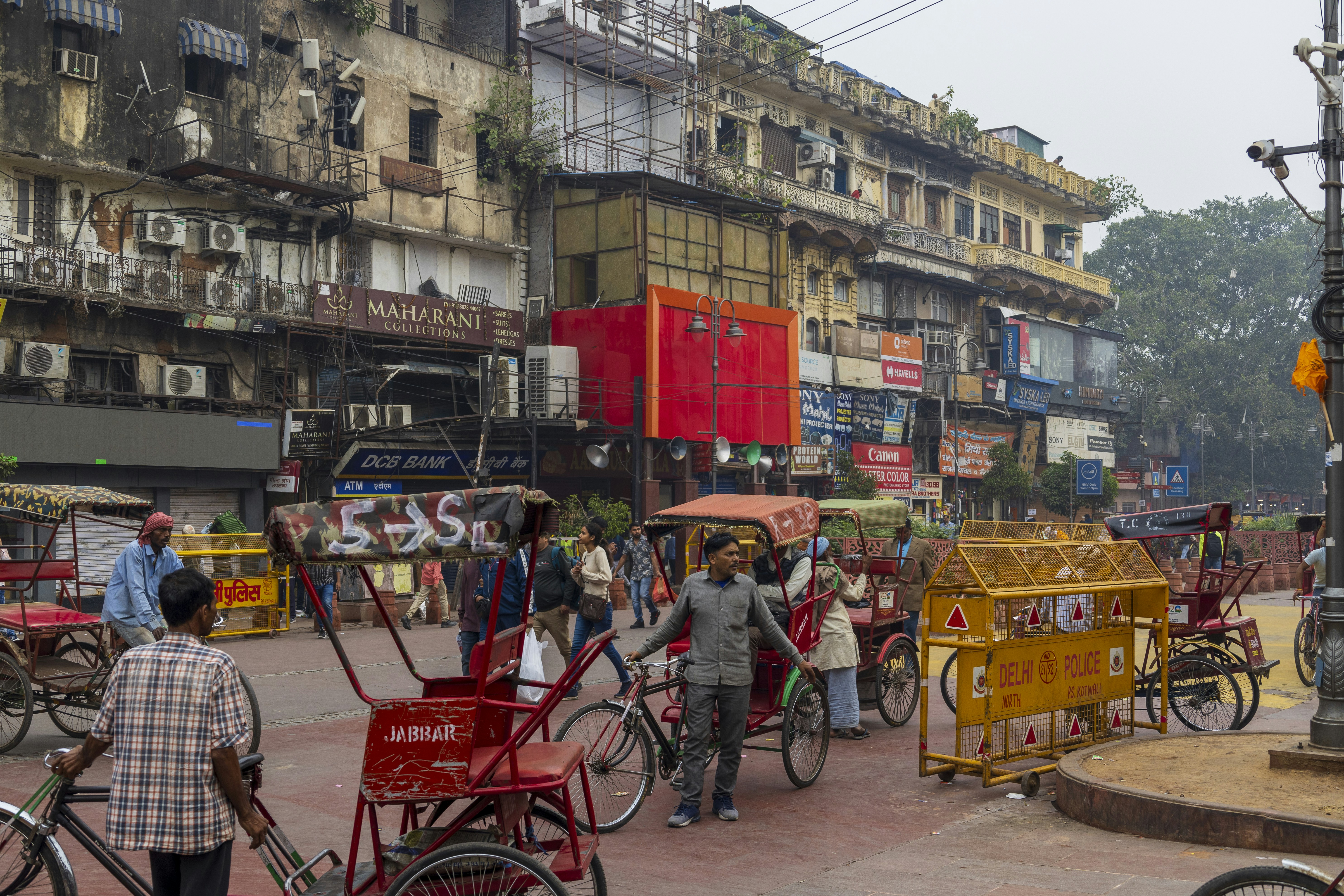 a group of people walking around a city street, 