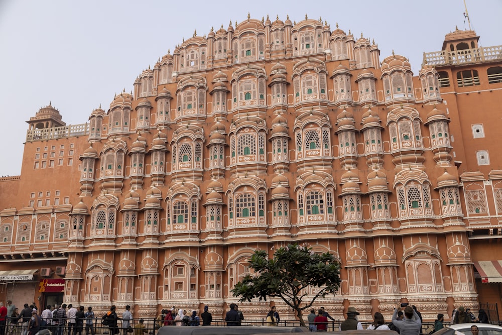 a large building with many windows and a tree in front of it