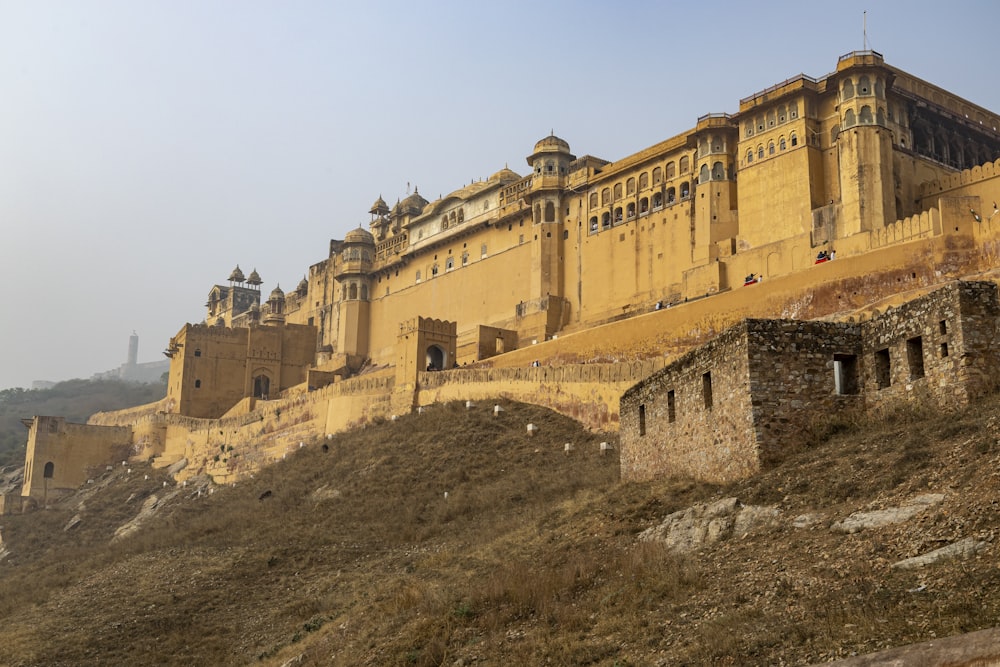 a large building on a hill with a sky background