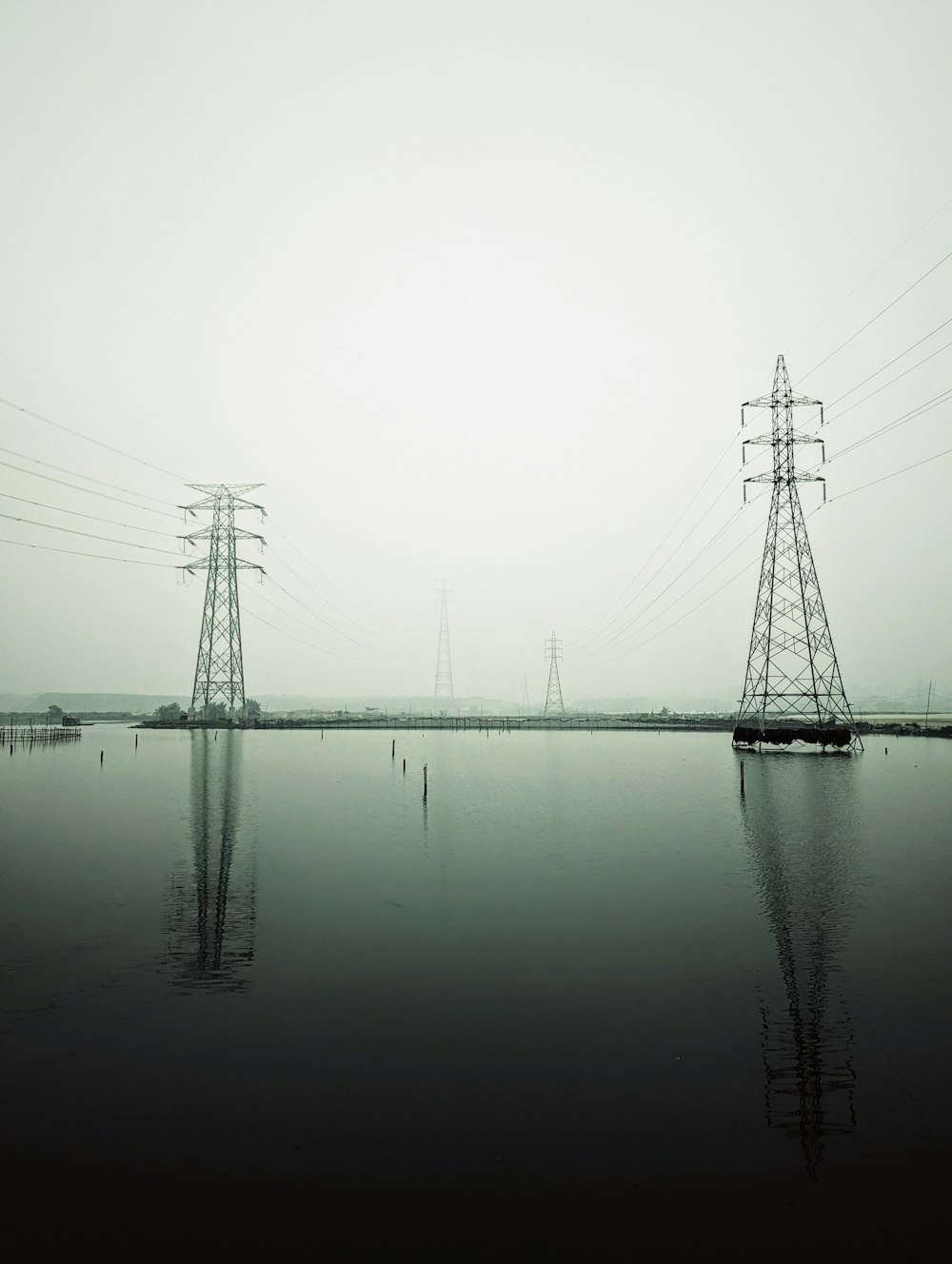 a body of water surrounded by power lines