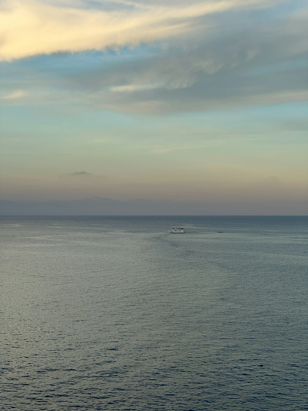 a small boat in the middle of a large body of water