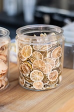 a couple of jars filled with sliced oranges