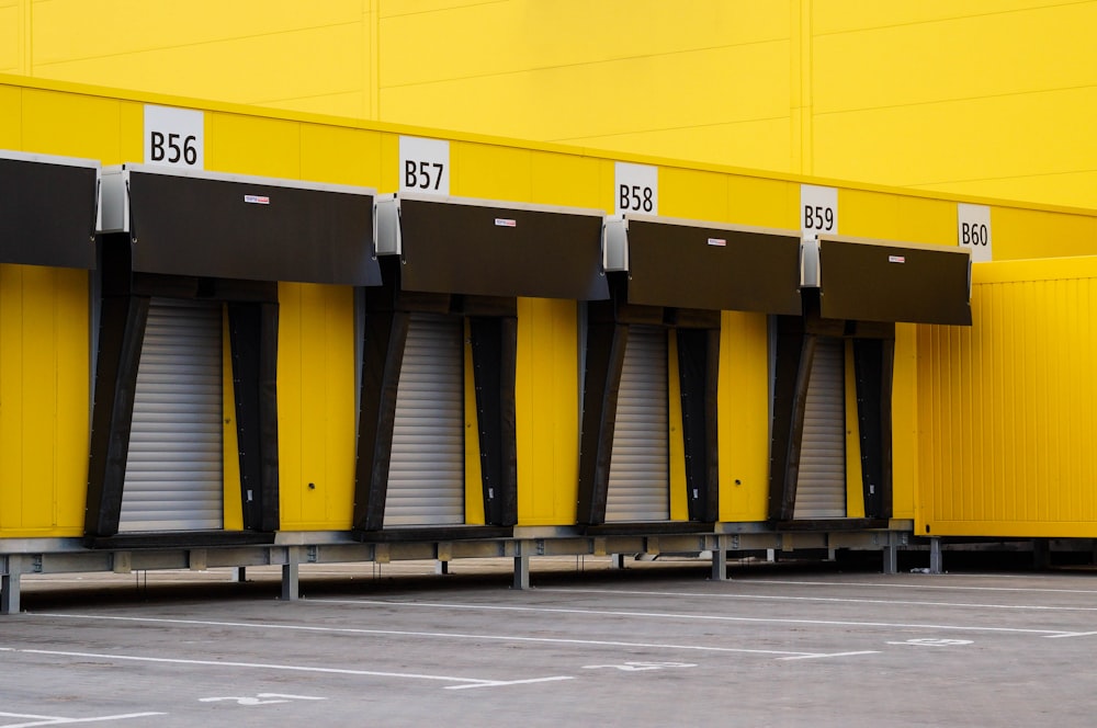 a row of yellow storage units in a parking lot
