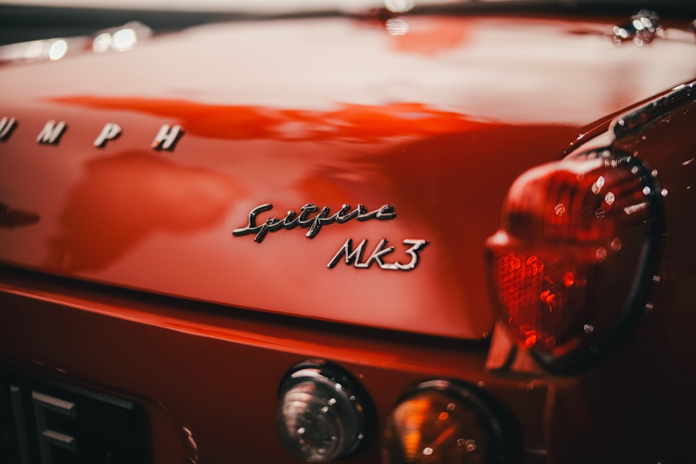 a close up of the tail end of a red car