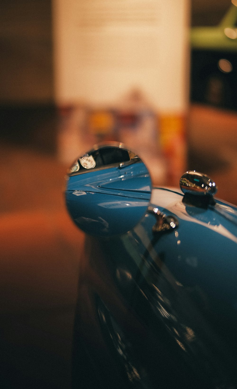 a close up of a shiny blue car hood ornament