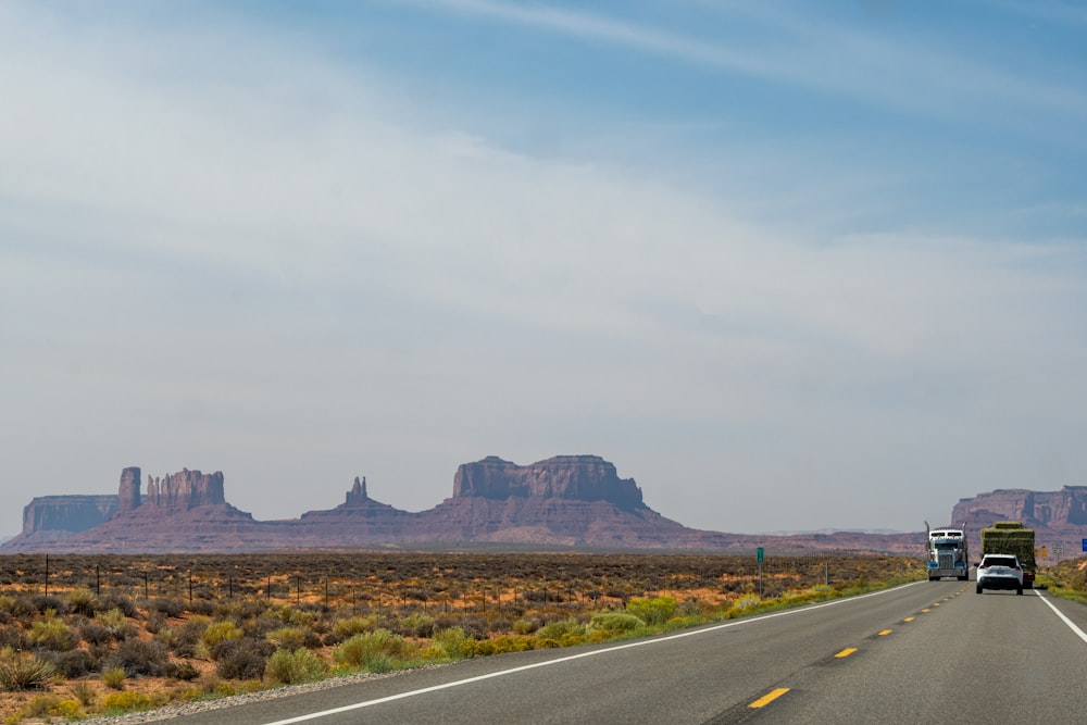 a truck driving down a highway in the desert