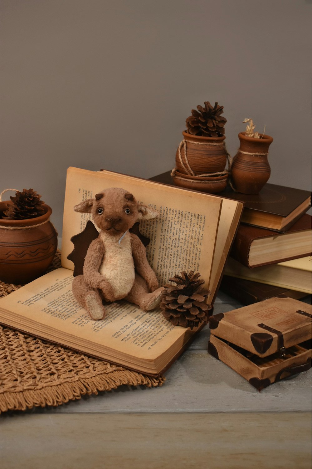 a stuffed animal sitting on top of an open book