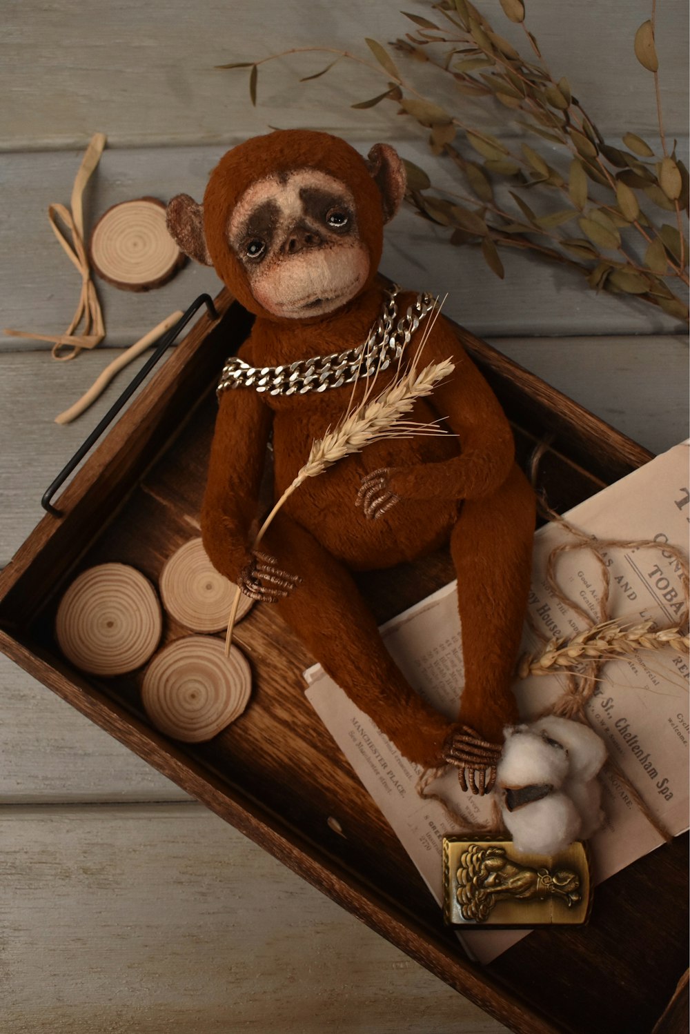 a stuffed monkey sitting in a wooden box