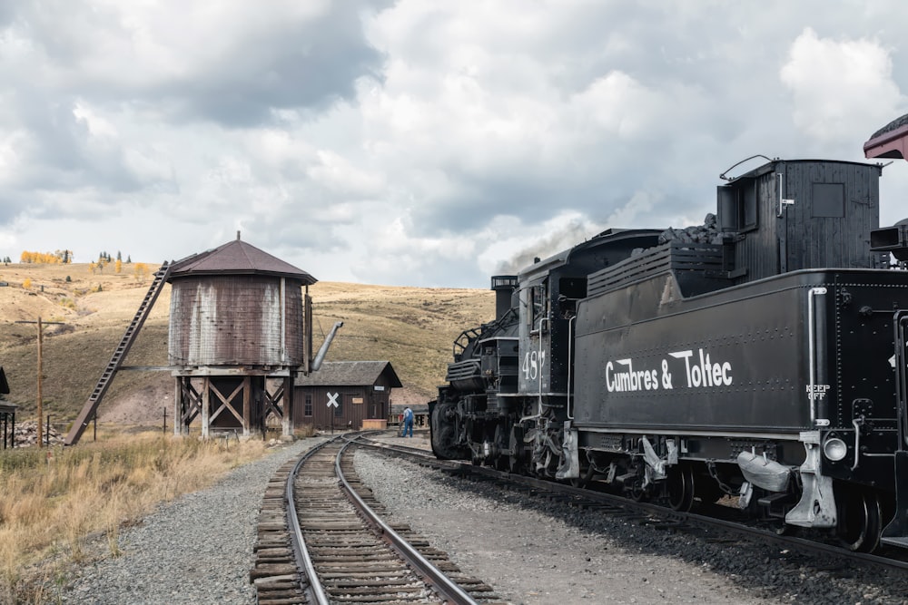 A water tower, the steam engine, and tender at tiny Osier, Colorado, on the Cumbres & Toltec Scenic Railroad trains’ route