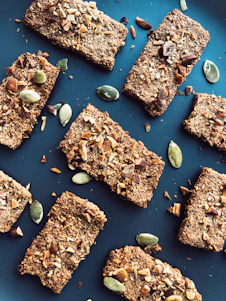 a blue plate topped with granola bars and nuts