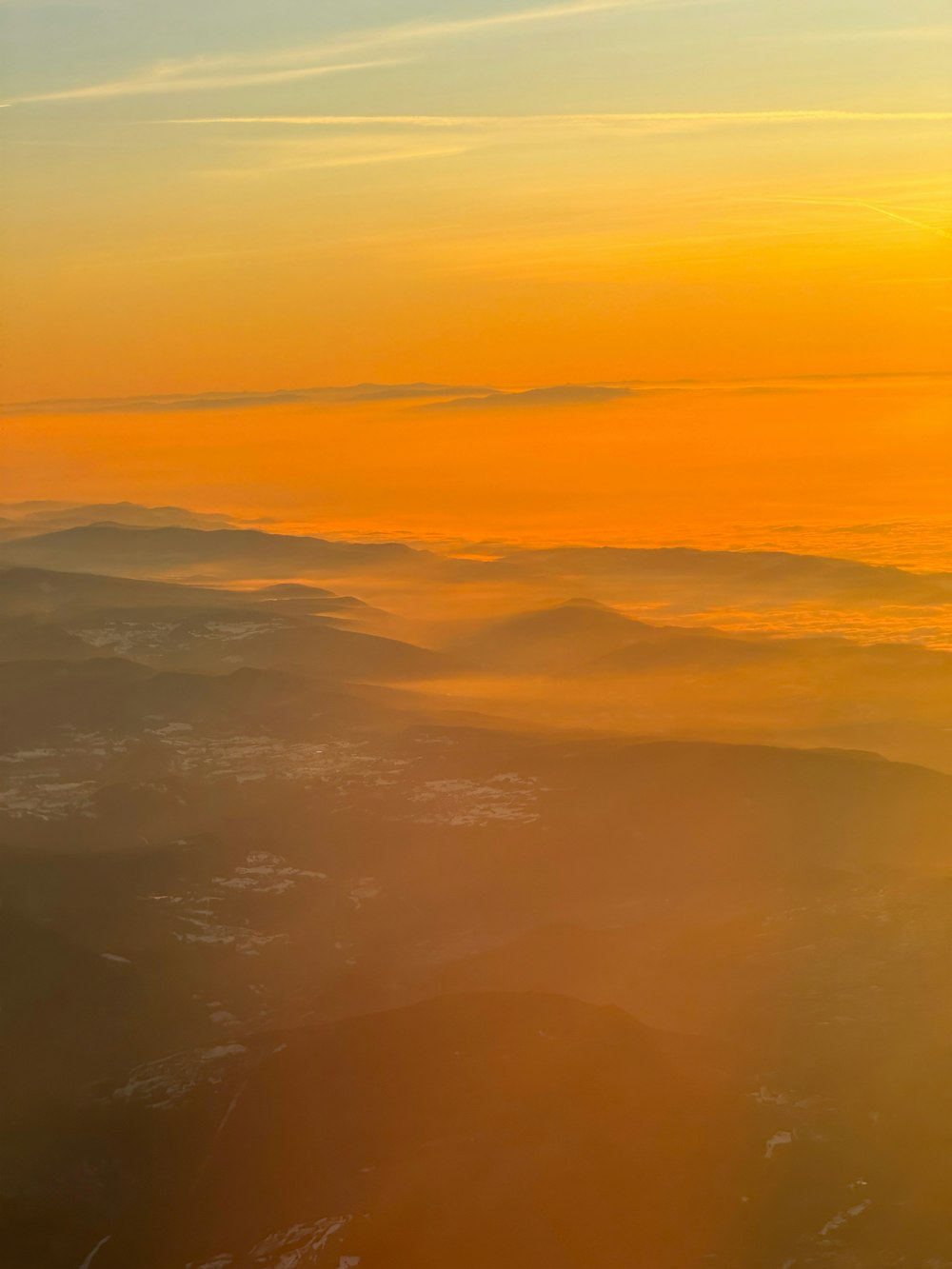 the sun is setting over a mountain range