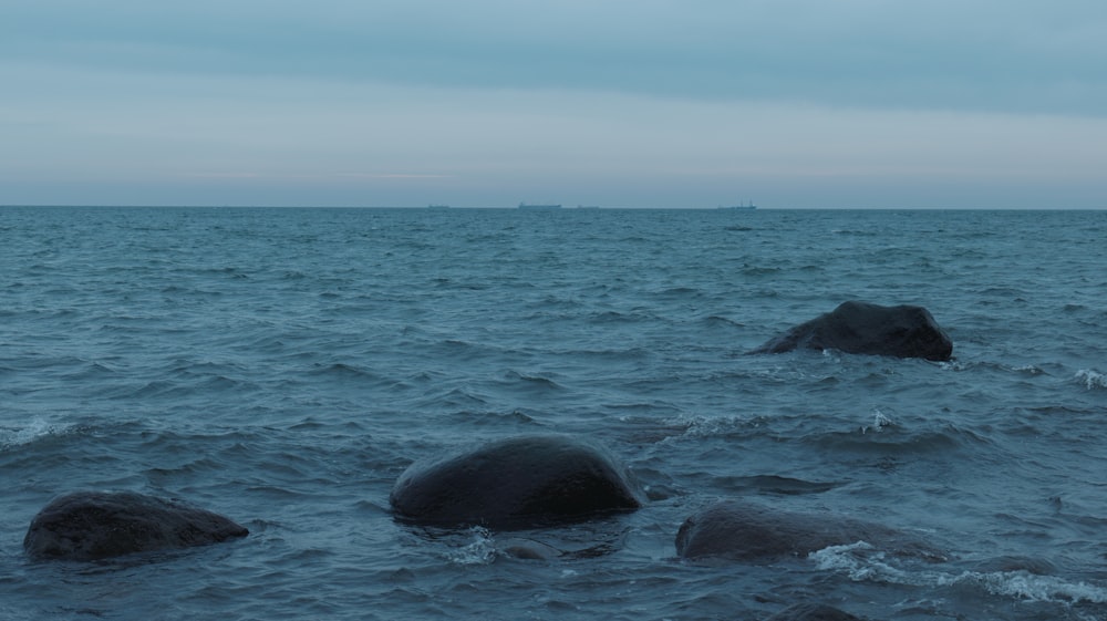 two large rocks in the middle of a body of water