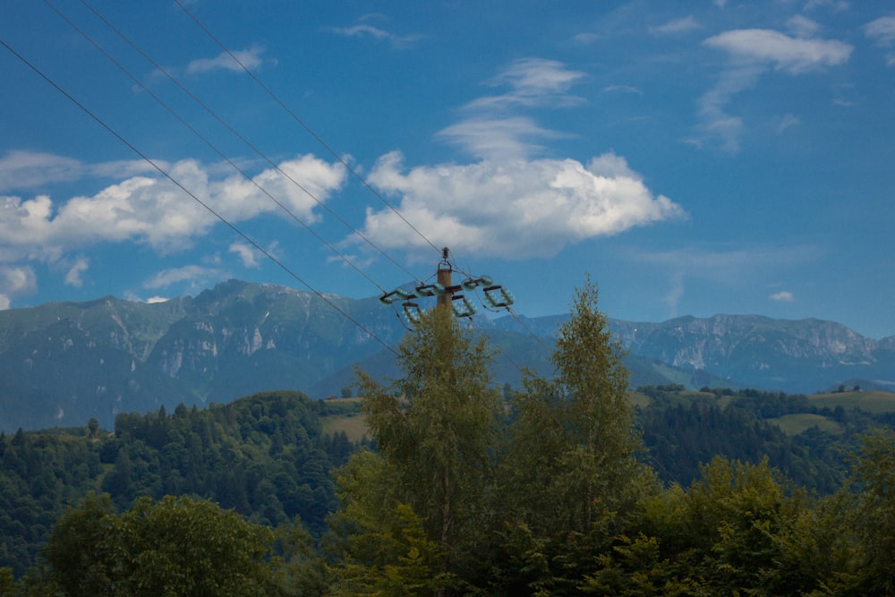 a view of a mountain range with power lines in the foreground