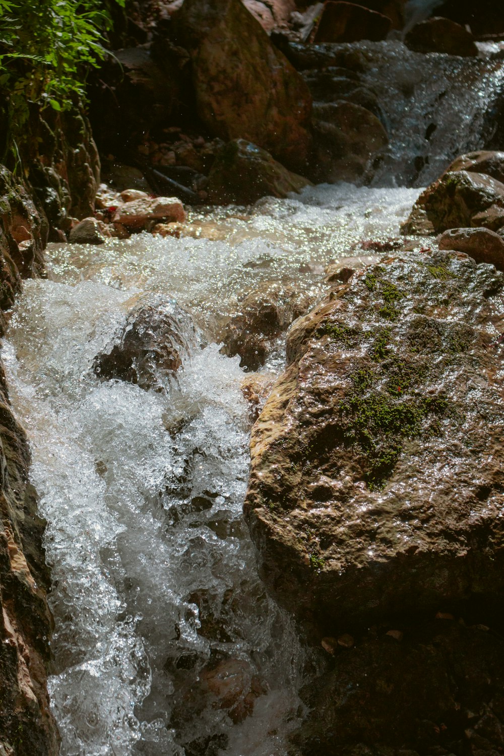 a small stream of water running between rocks