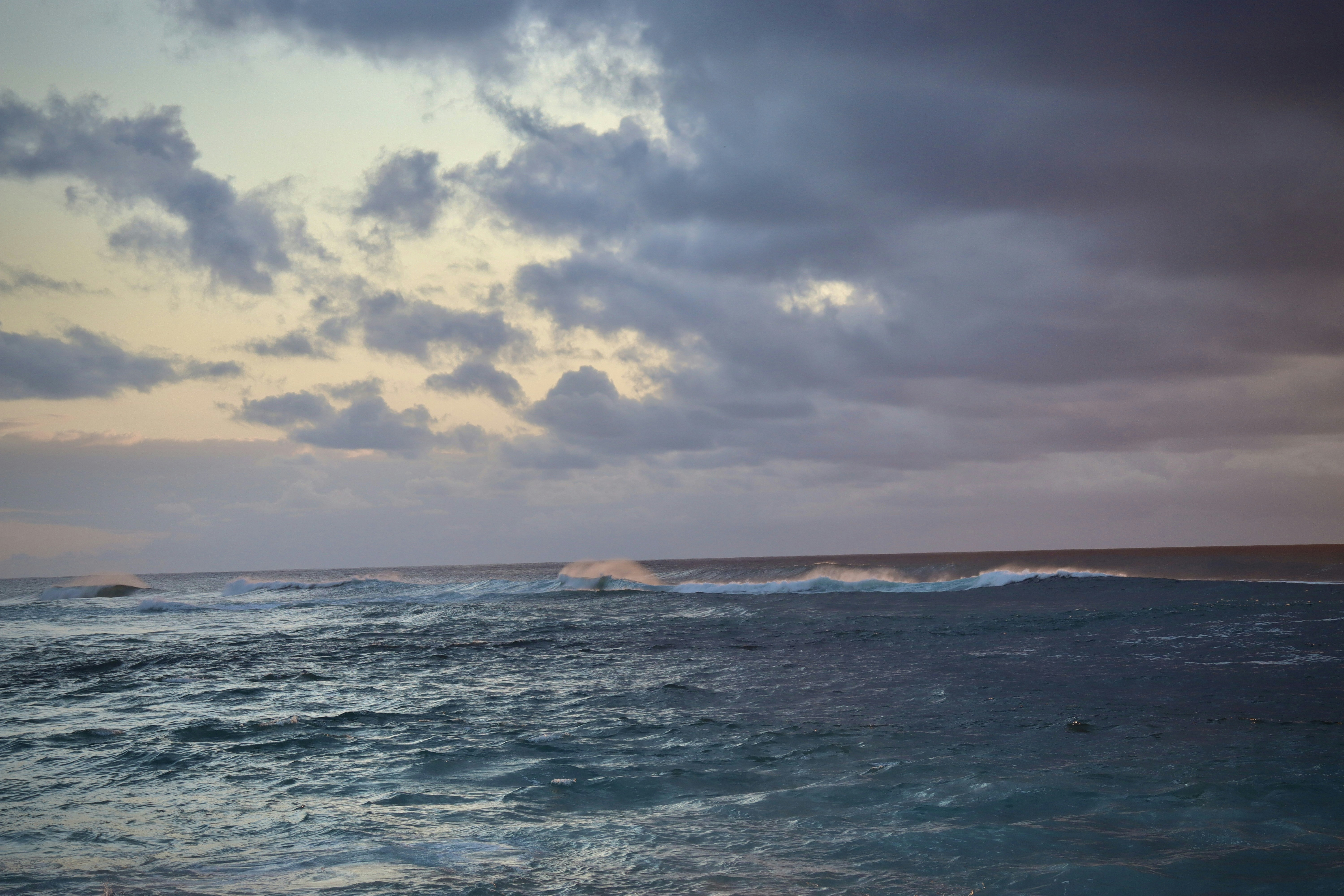a large body of water under a cloudy sky