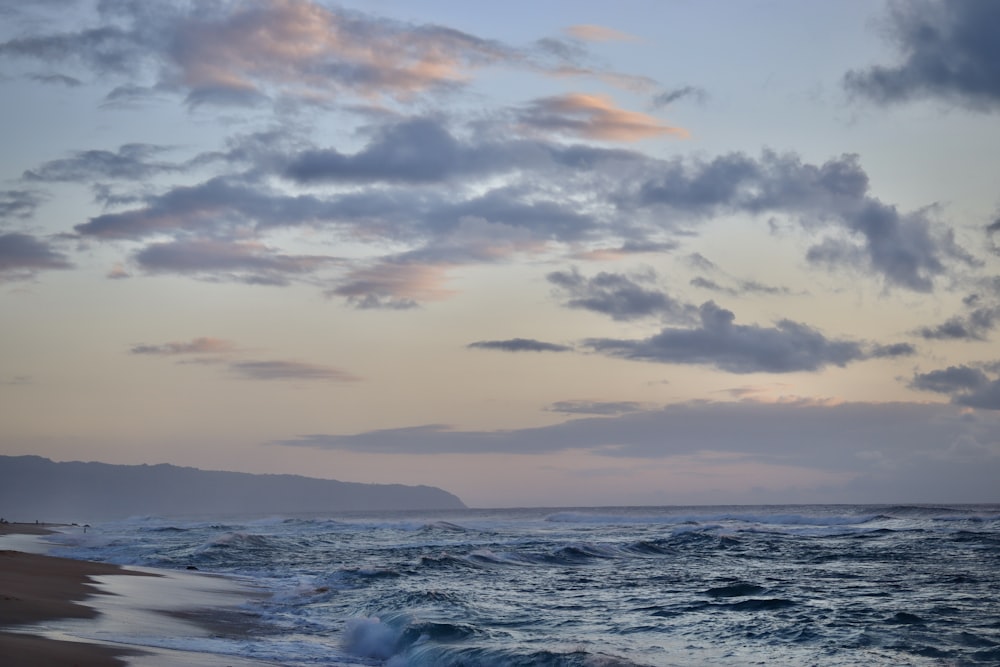 a beach with waves crashing on the shore