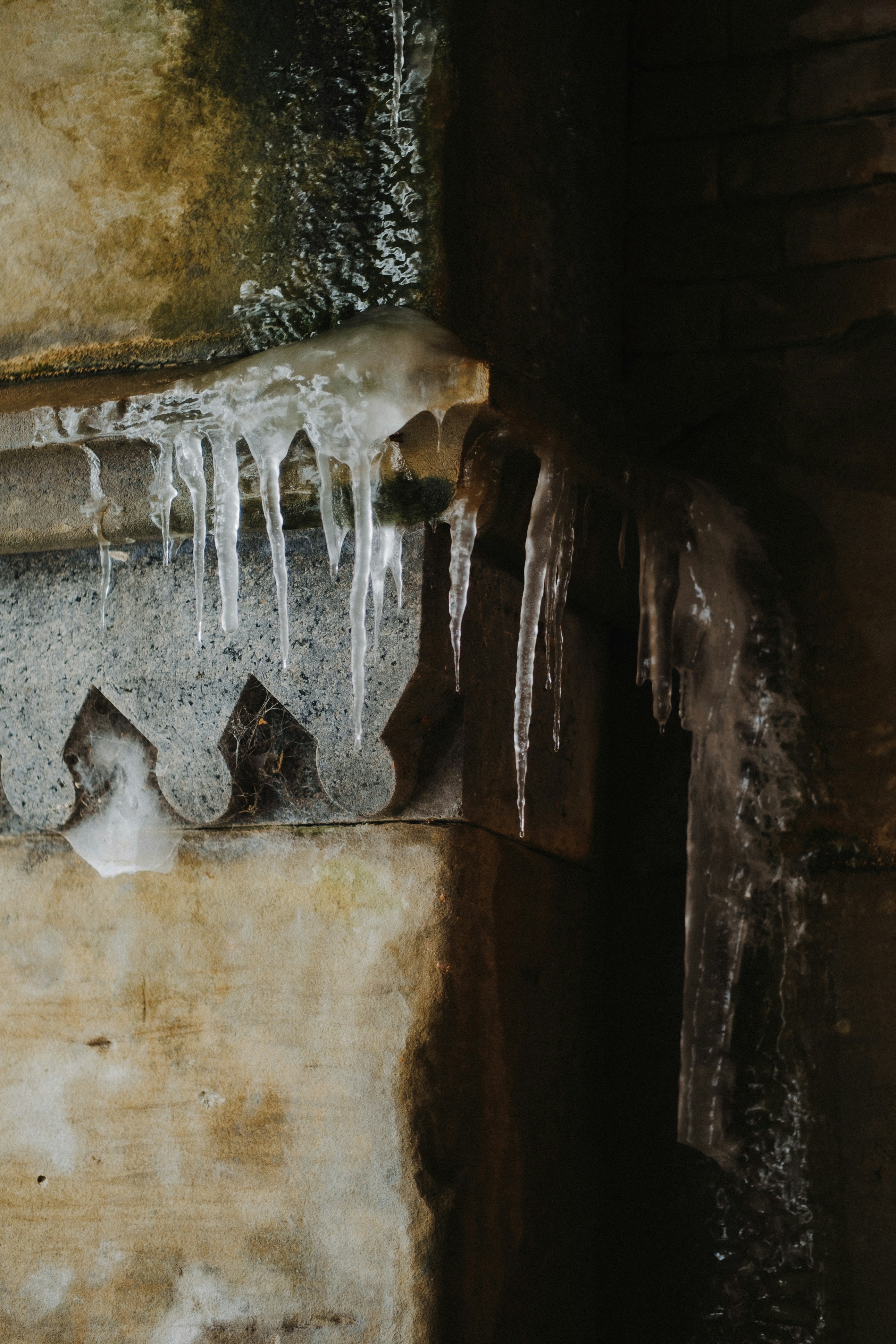 icicles hang from the side of a building