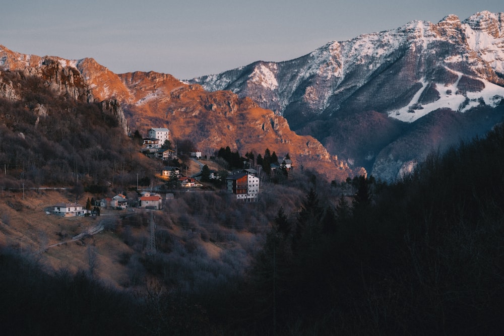 a view of a mountain with a village in the foreground