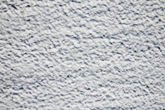 a textured background of white and blue paint
