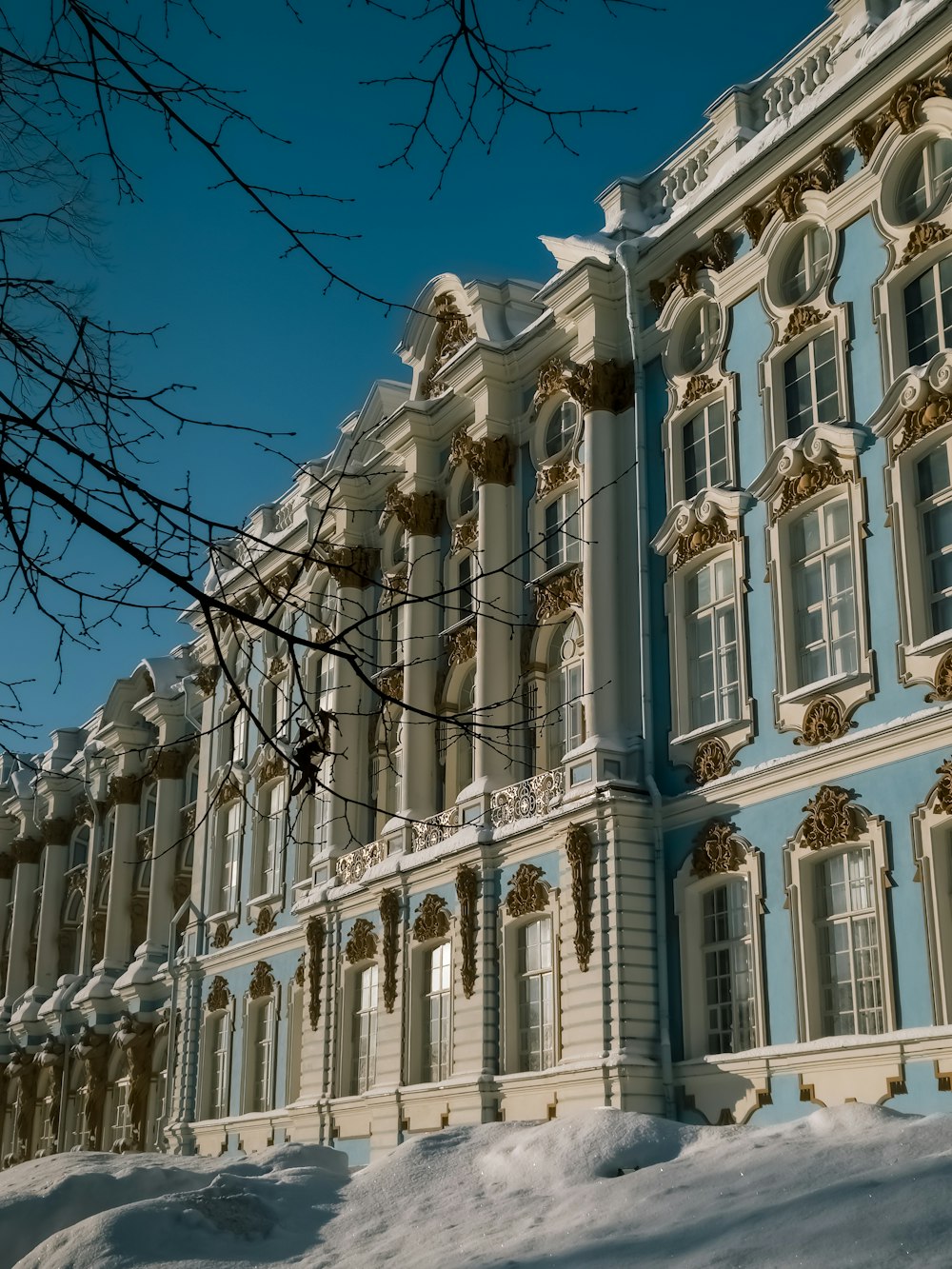 a large blue and white building with snow on the ground