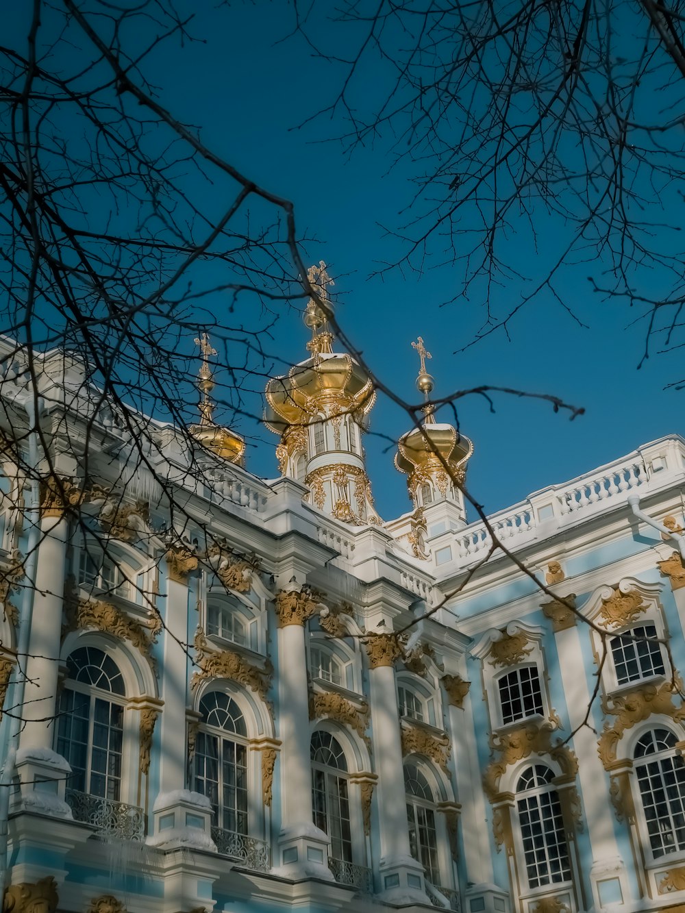 a large building with a golden clock on it's side