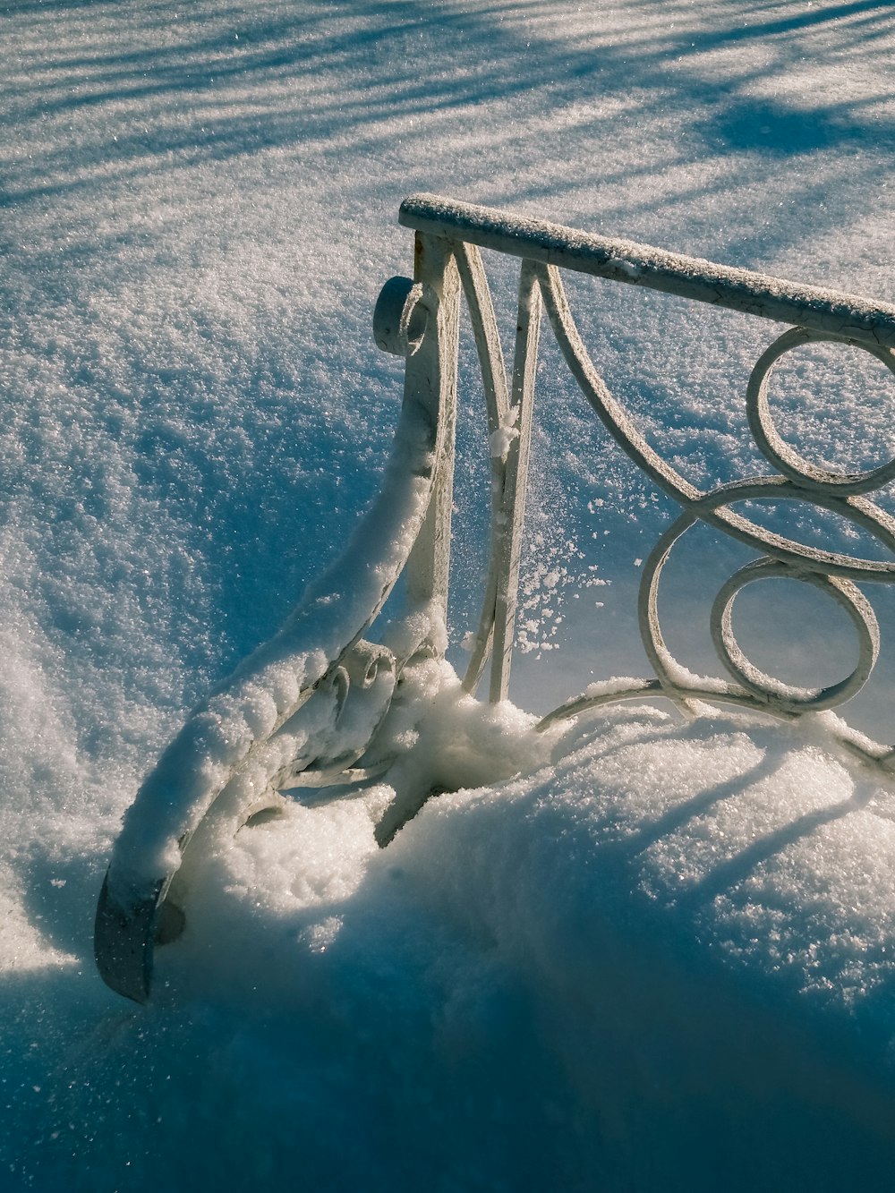 a bench that is covered in snow in the snow