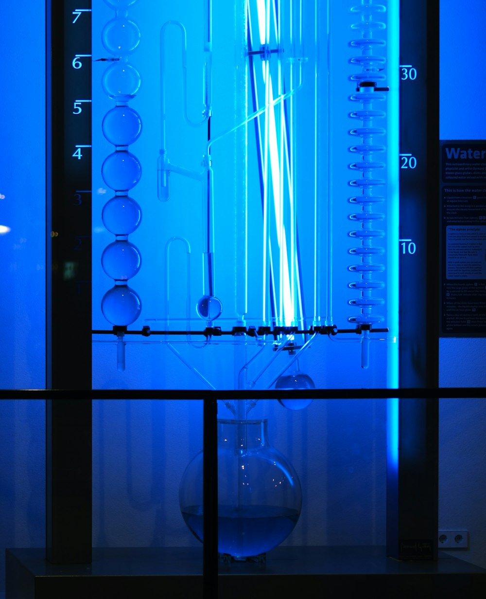 a blue light is shining on a glass case