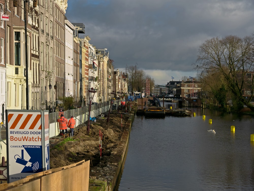 a body of water next to a row of buildings