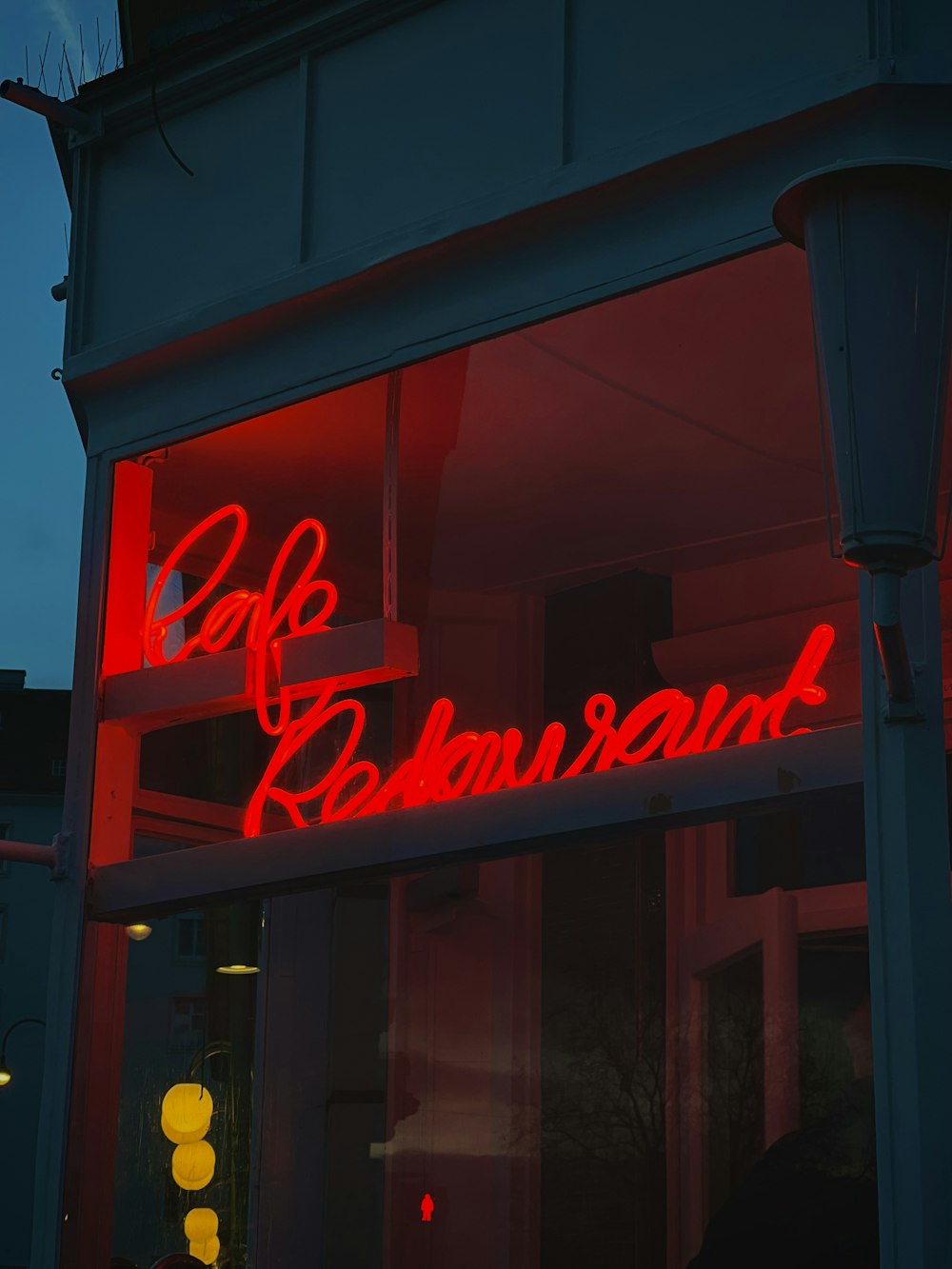 a red neon sign on the side of a building