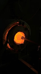 a man working in a metal shop with a torch