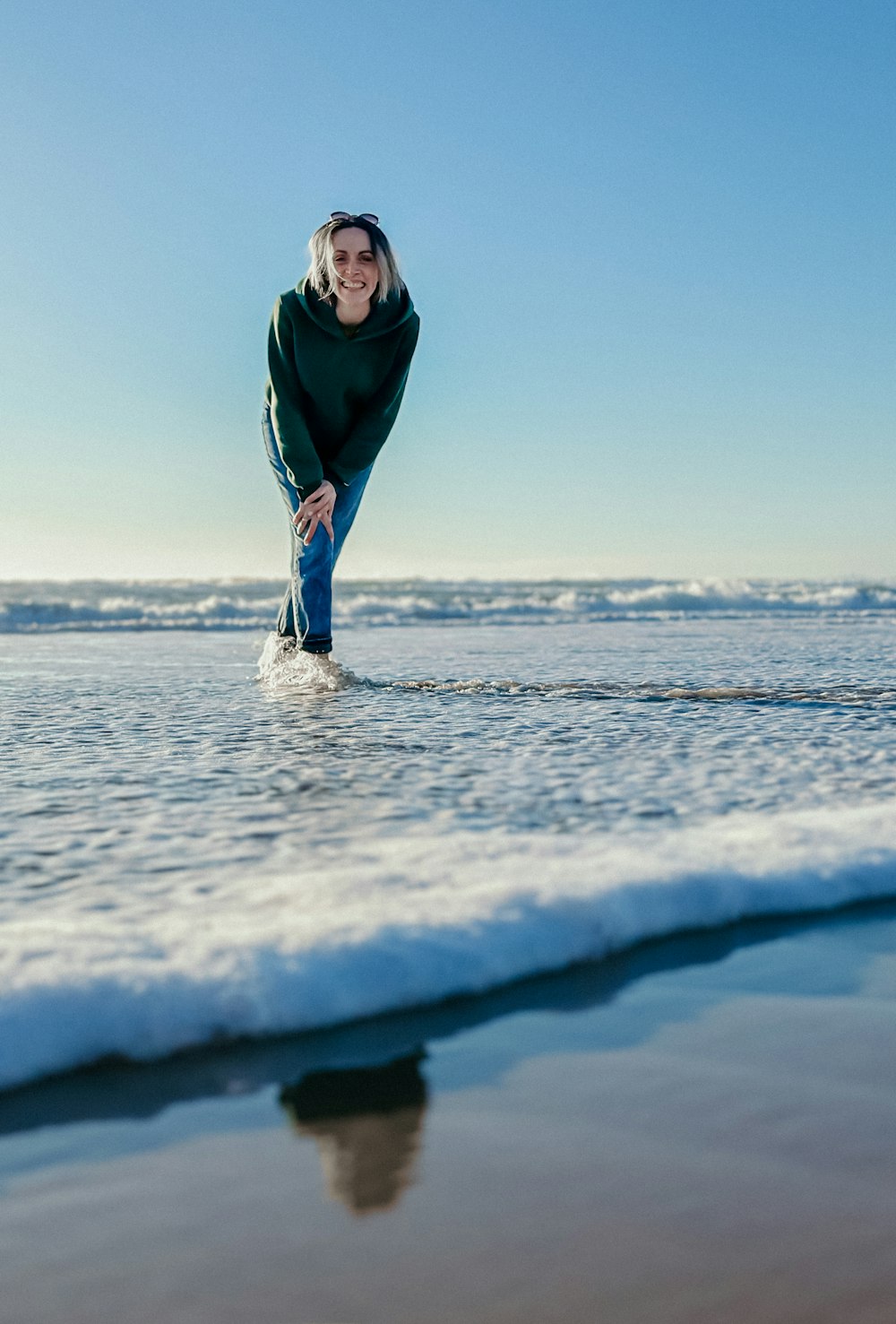 a woman standing in the water at the beach