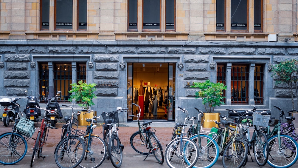 a bunch of bikes parked in front of a building