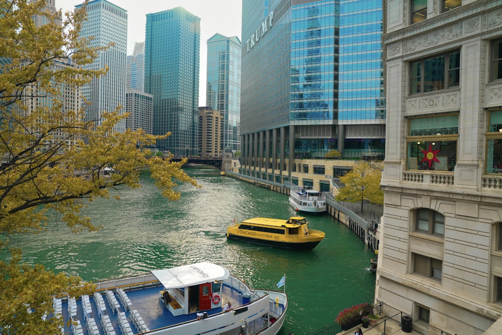 two boats are docked in a river in a city