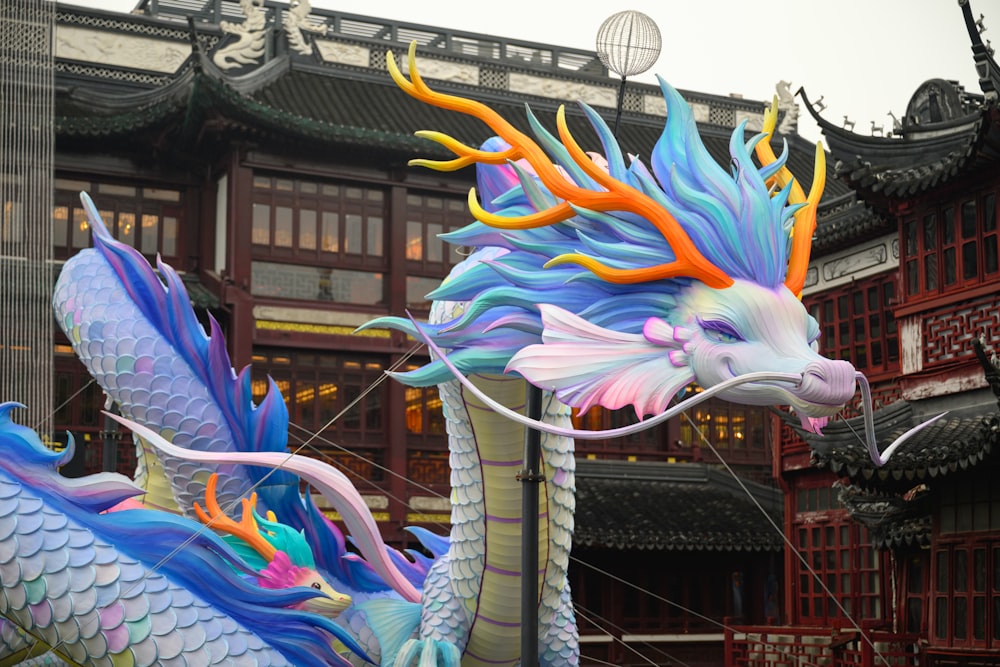 a dragon kite is being flown in front of a building