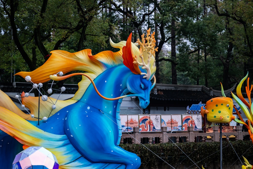 a float of a blue horse with a crown on it's head