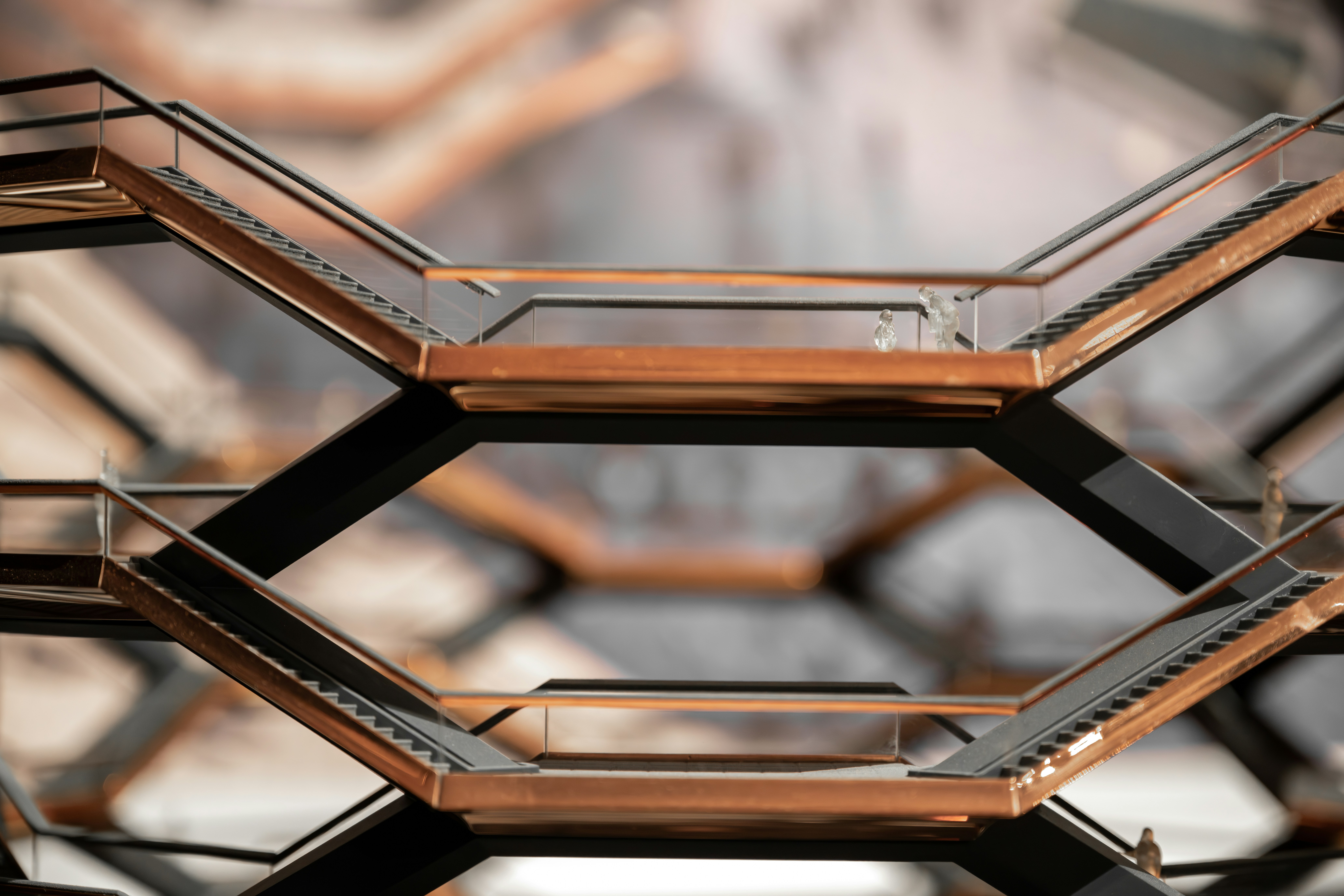 a close-up of a metal structure with a clock in the background