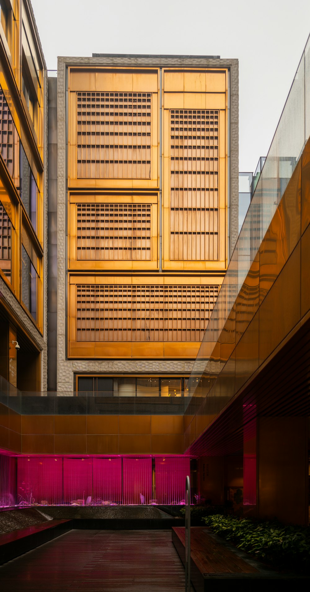 a building with a lot of windows and a bench in front of it