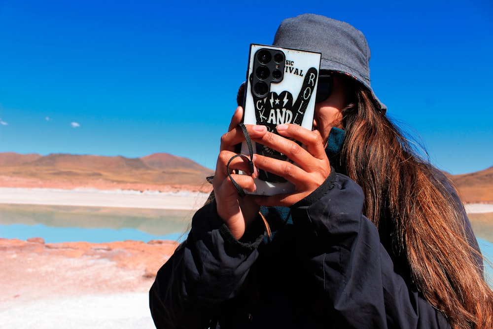 a woman taking a picture with her cell phone