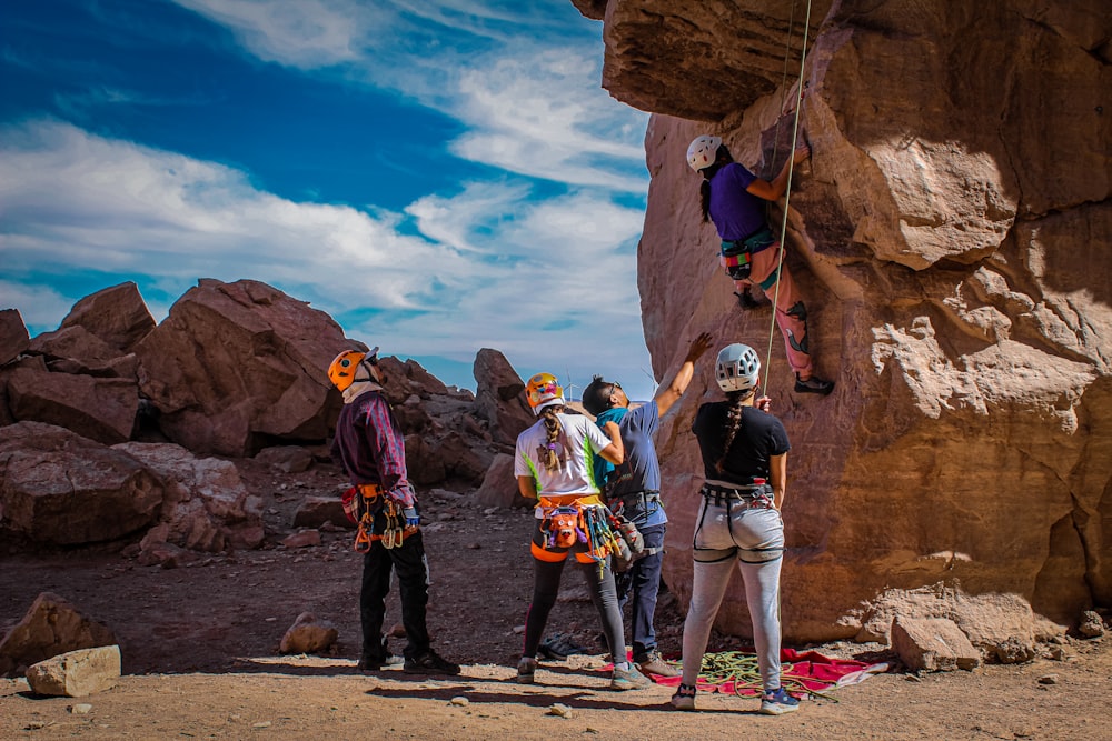 a group of people standing on top of a cliff