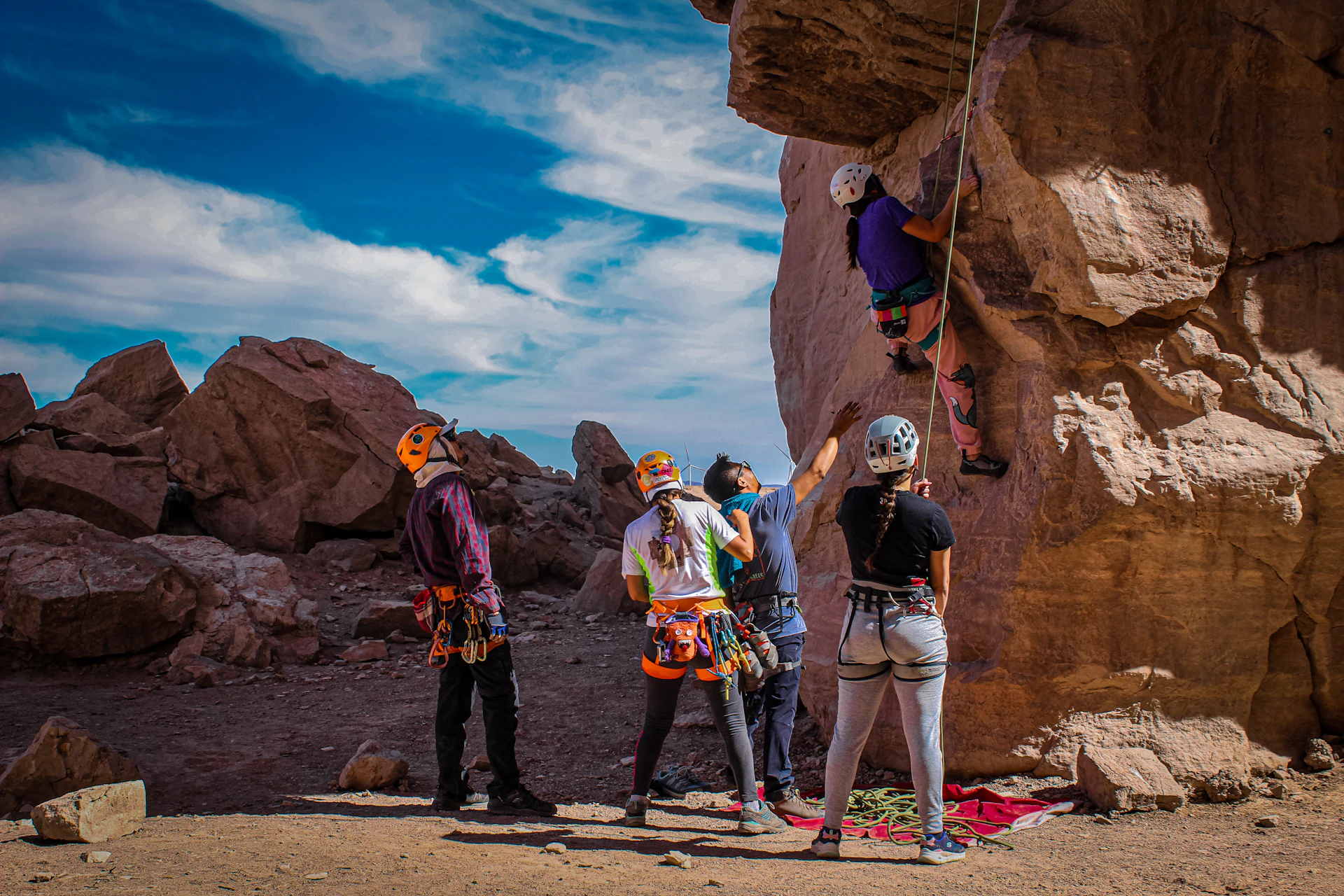 a group of people standing on top of a cliff