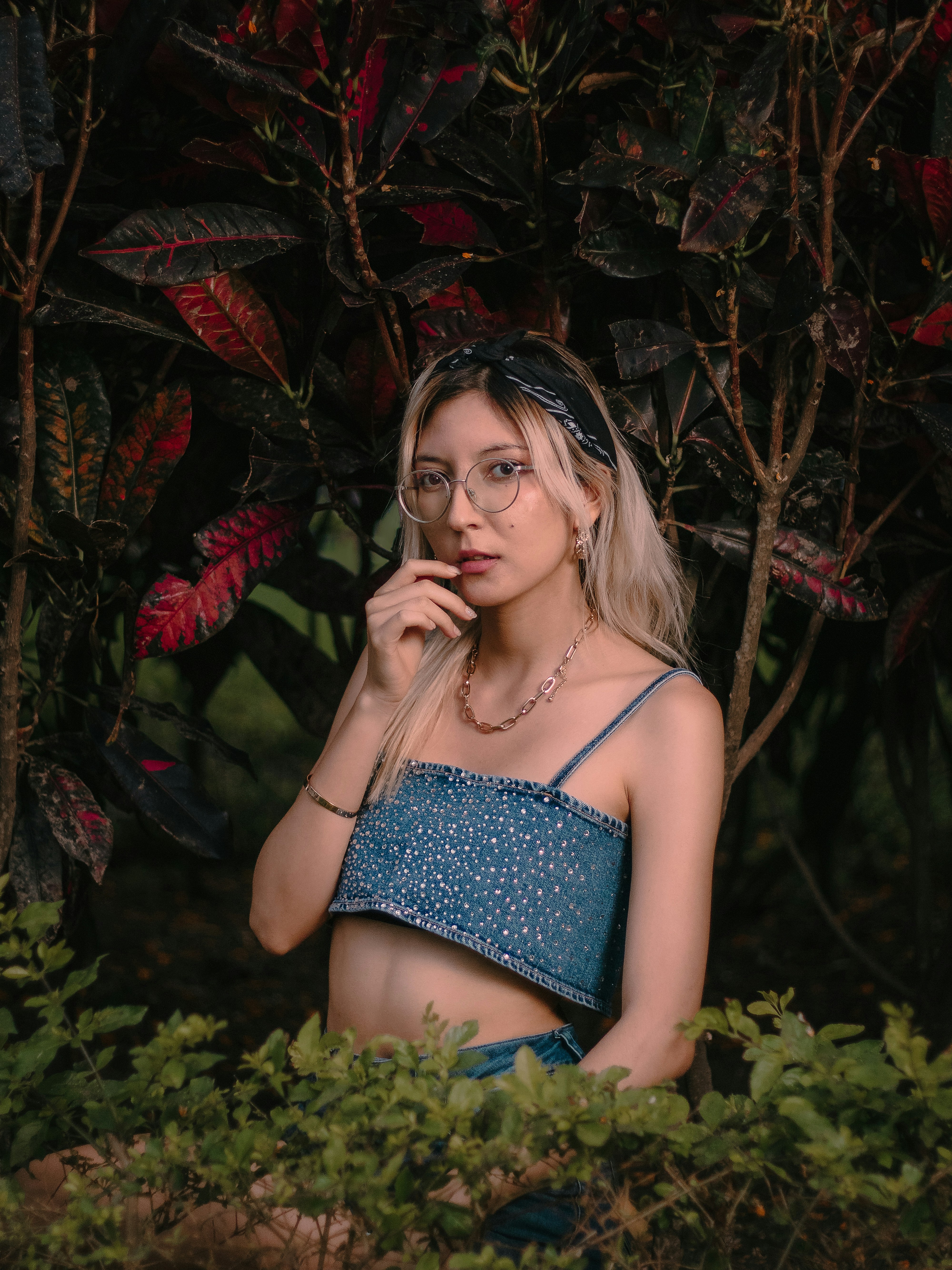 a woman in a blue top is posing for a picture