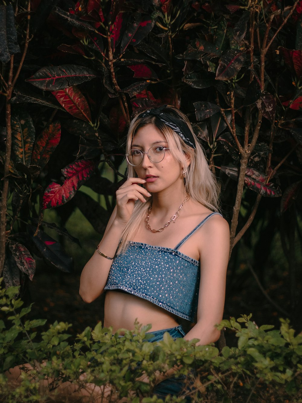 a woman in a blue top is posing for a picture