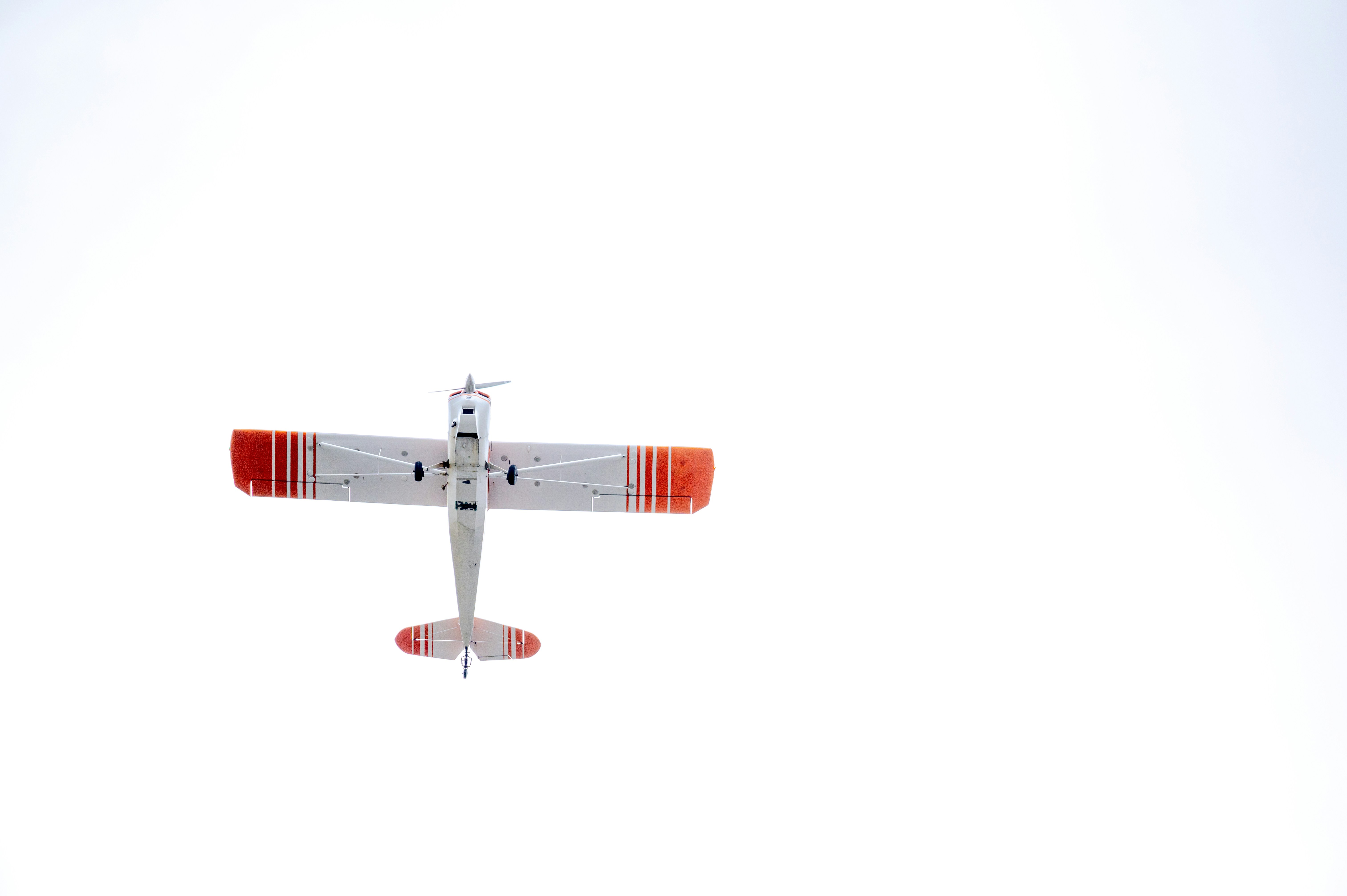 a red and white airplane flying in the sky