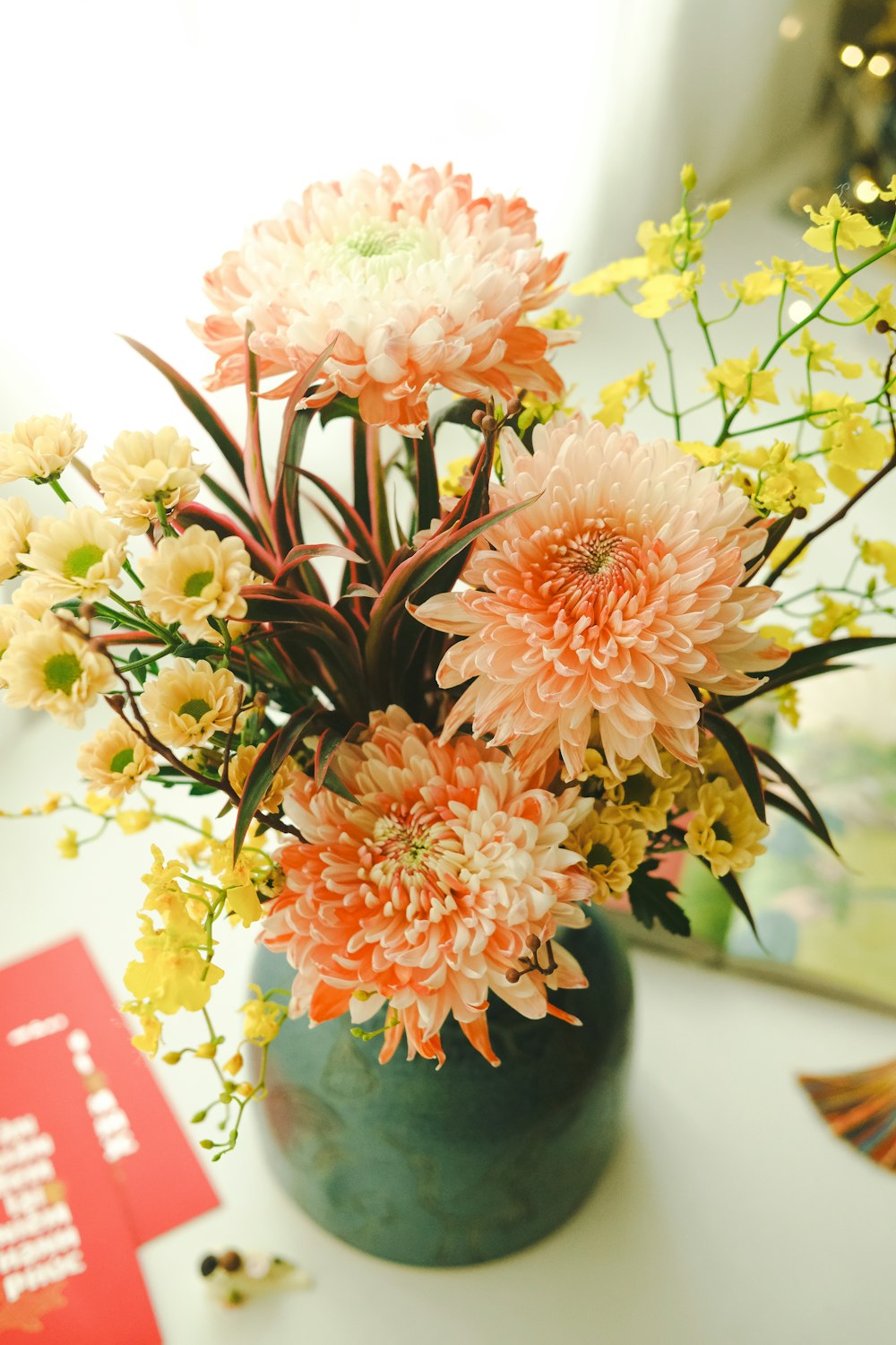 a vase filled with lots of flowers on top of a table