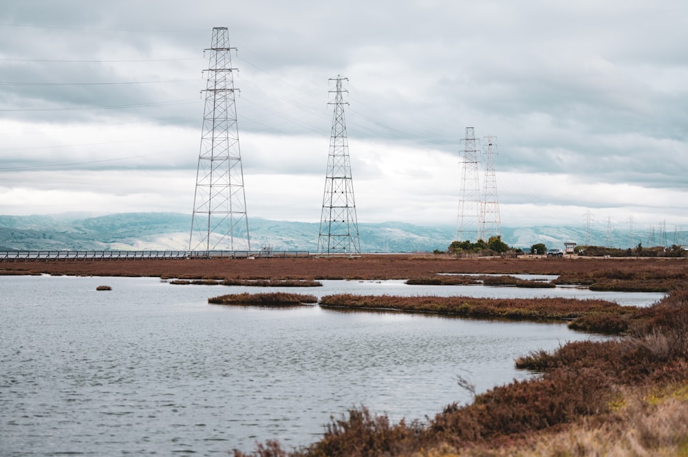 a body of water surrounded by power lines